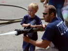 June 1, 2013NEWS PHOTO CHARLES LEFEBVREMedicine Hat firefighter Josh Hauck helps Damien Davies operate a fire hose during a Spectrum activity on Third Street Saturday afternoon. June 1, 2013NEWS PHOTO CHARLES LEFEBVREMedicine Hat firefighter Josh Hauck helps Damien Davies operate a fire hose during a Spectrum activity on Third Street Saturday afternoon.